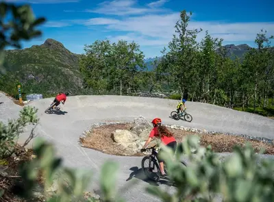a group of people riding bikes on a road at Family-Friendly Ski in-Ski out Retreat by Skarsnuten in Hemsedal