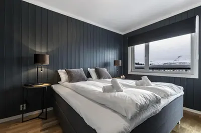 a large white bed in a room with a window at Ski in-Ski out with Style and Scenic Views in Hemsedal