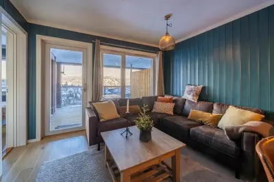 a living room with a couch and a table at Ski in-Ski out and Perfect for Families in Hemsedal