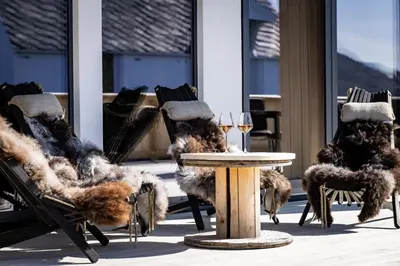 a group of chairs covered in faux fur next to a table at Rosenlund Hamn in Sande