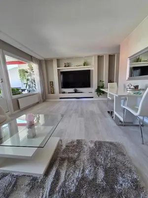 a living room with a large television and a table at Apartment, everything close in Hamar
