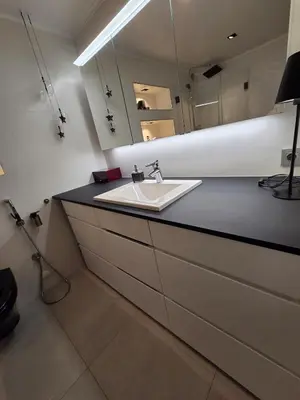 a bathroom with a sink and a mirror at Apartment, everything close in Hamar
