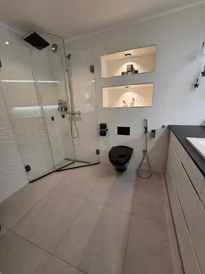 a bathroom with a black toilet and a shower at Apartment, everything close in Hamar