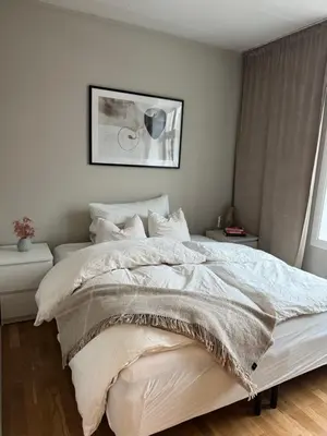 a bedroom with a large bed with white blankets and pillows at Nice apartment super central at Solsiden in Trondheim