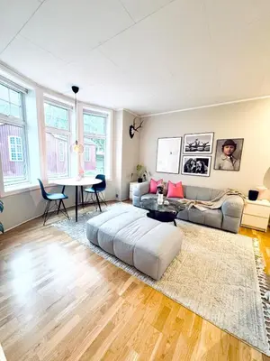 a living room with a couch and a table at Nice apartment super central at Solsiden in Trondheim
