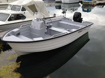 a white boat is docked in the water at Strand farm, sea view and boat rental in Averoy