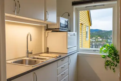 a kitchen with a sink and a window at Small house close to nature and city in Bergen