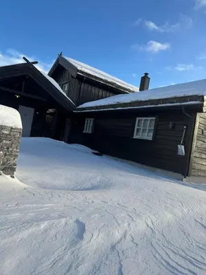 a house with a pile of snow in front of it at Nice cottage in quiet surroundings, surrounded by beautiful nature, near Gullingen in Gullingen
