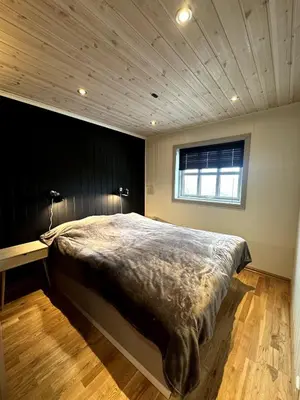 a bedroom with a large bed and a window at Nice cottage in quiet surroundings, surrounded by beautiful nature, near Gullingen in Gullingen