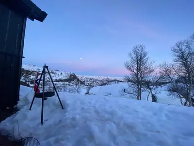 a swing in the snow next to a house at Nice cottage in quiet surroundings, surrounded by beautiful nature, near Gullingen in Gullingen
