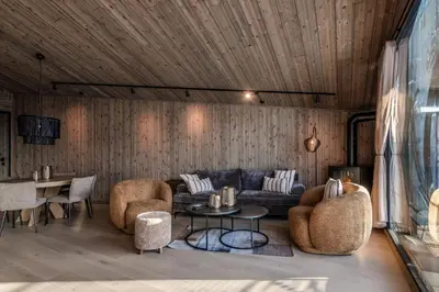 a living room with a couch and chairs and a table at Kikut Alpin Lodge 1302 in Geilo