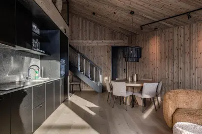 a kitchen with a table and chairs in a room at Kikut Alpin Lodge 1302 in Geilo