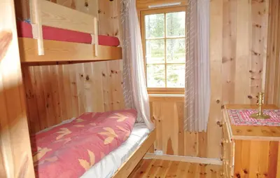 a bedroom with a bunk bed and a window at Cozy Home In Rendalen With Sauna in Akrestrommen