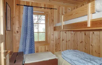 a bedroom with two bunk beds and a window at Cozy Home In Rendalen With Sauna in Akrestrommen