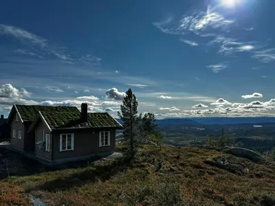 a small house sitting on top of a hill at Mountain Cabin With Panoramic Views In Valdres in Etnedal