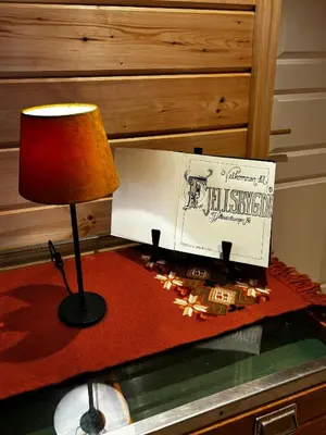 a table with a lamp and a box on it at Mountain Cabin With Panoramic Views In Valdres in Etnedal