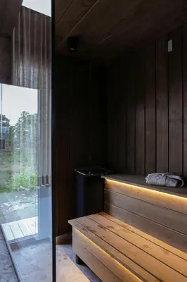 a sauna with a bench in a room with a window at Modern Mountain Cabin With Views In Hovden in Hovden