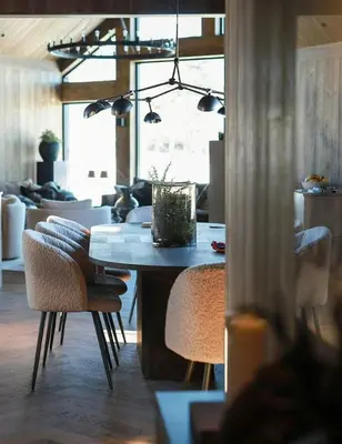 a dining room with a table and chairs and a room at Modern Mountain Cabin With Views In Hovden in Hovden