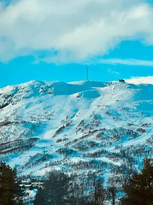 a snow covered mountain with a cross on top of it at Modern Mountain Cabin With Views In Hovden in Hovden