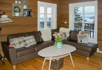 a living room with a couch and a table at Log Cabin By Mostertoppen Ski Stadium in Øyer