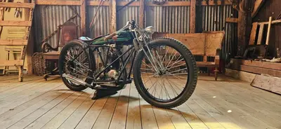 a motorcycle parked on a wooden floor in a barn at Retro & Vintage Camping in Vaksdal
