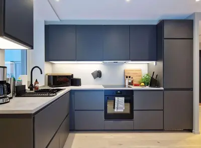a kitchen with blue cabinets and a stove top oven at Brand New & High-End 3 Bedrooms 2 Bathrooms Central Apartment in Bergen