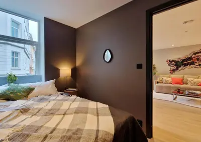 a bedroom with a bed and a large mirror at Brand New & High-End 3 Bedrooms 2 Bathrooms Central Apartment in Bergen