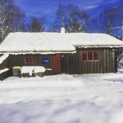 a cabin with snow on the roof of it at Rauland Hytteutleige in Rauland