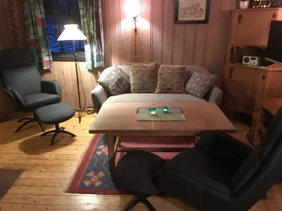 a living room with a table and a couch at Rauland Hytteutleige in Rauland