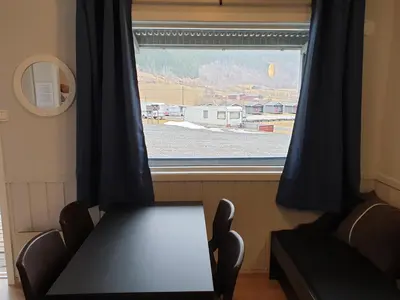 a table and a chair in front of a window at Tvinde Camping in Skulestadmo