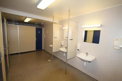 a bathroom with two sinks and a mirror at Tvinde Camping in Skulestadmo