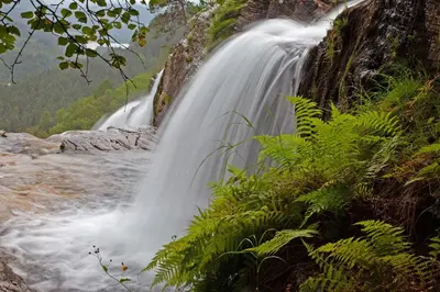 a waterfall on the side of a river at Tvinde Camping in Skulestadmo