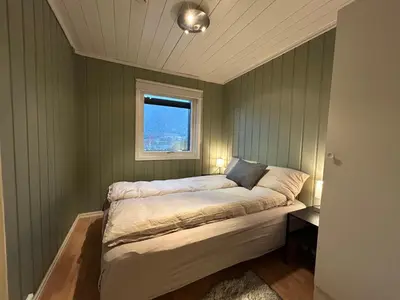 a bed in a room with a window at Hafjell Ski-in Ski-Out in Øyer