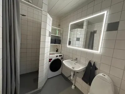 a bathroom with a sink and a toilet and a mirror at Hafjell Ski-in Ski-Out in Øyer