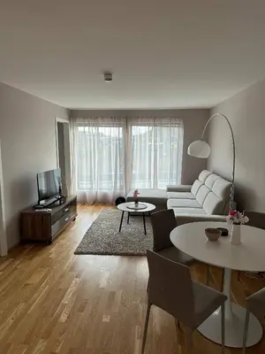a living room with a white couch and a tv at Apartament Near Haugesund in Skred