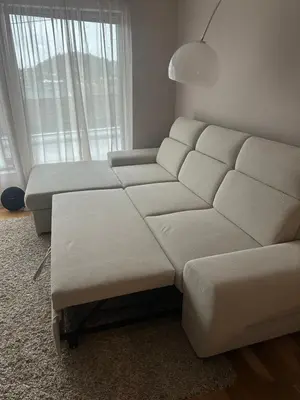 a living room with a white couch and a table at Apartament Near Haugesund in Skred