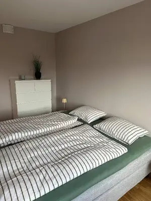 a bed with two pillows on it in a bedroom at Apartament Near Haugesund in Skred