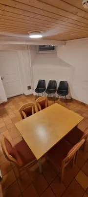 a conference room with a wooden table and chairs at Big and cozy room in the middle of the city in Trondheim