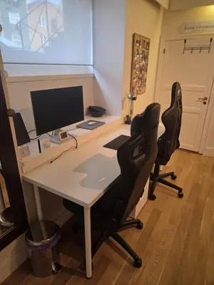 an office with a desk with a computer and two chairs at Big and cozy room in the middle of the city in Trondheim