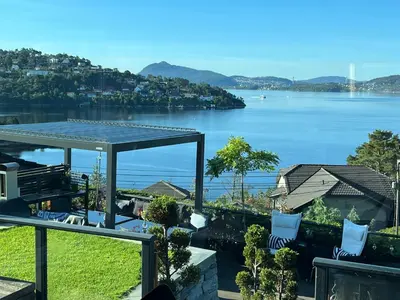 a view of a body of water from a balcony at Villa med 5 soverom, 4 bad og 3 kjøkken, 400 m fra lokal badestrand in Bergen