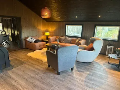 a living room with couches and chairs at Bottheimsætra