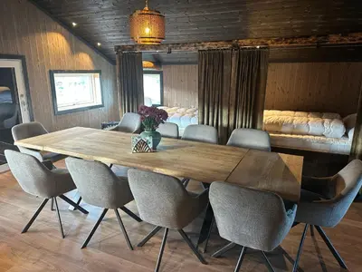 a wooden table and chairs in a room at Bottheimsætra