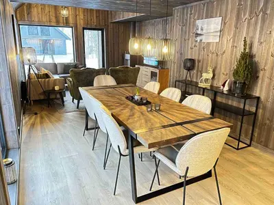 a dining room with a wooden table and chairs at Nice cabin at Norefjell skicenter in Noresund