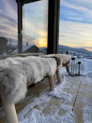 a row of benches covered in snow in front of a window at Nice cabin at Norefjell skicenter in Noresund
