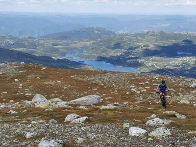 a person riding a bike on top of a mountain at Nice cabin at Norefjell skicenter in Noresund