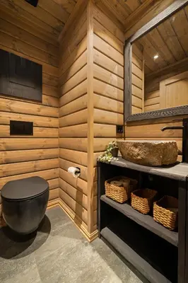a bathroom with a black toilet and a sink at The Nordic Retreat - Stryn in Stryn