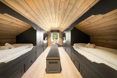 a room with two beds and a table in the middle at The Nordic Retreat - Stryn in Stryn