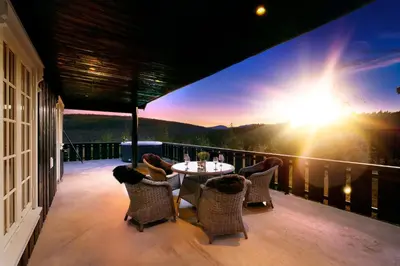 a patio with a table and chairs on a balcony at The Nordic Retreat - Stryn in Stryn
