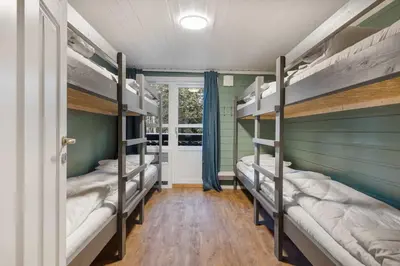 a room with three bunk beds and a window at Alpingrenda 38B by Vacation Trysil in Trysil