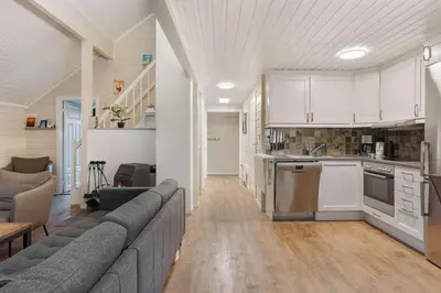 a living room with a couch and a kitchen at Alpingrenda 38B by Vacation Trysil in Trysil